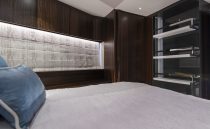 Luxurious interior of 2021 Sunseeker Manhattan 68 yacht bedroom with elegant wood finishes.