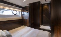 Luxurious cabin interior of 2021 Sunseeker Manhattan 68 yacht with elegant wood finishes.