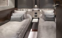 Luxurious twin cabin interior of 2021 Sunseeker Manhattan 68 yacht, featuring modern design and ambient lighting.