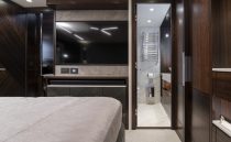 Luxurious interior of 2021 Sunseeker Manhattan 68 yacht with modern bedroom and ensuite bathroom.