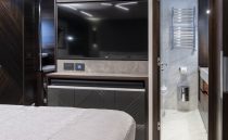 Luxurious interior of 2021 Sunseeker Manhattan 68 yacht with modern bedroom and ensuite bathroom.
