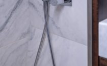 Luxurious interior of 2021 Sunseeker Manhattan 68 yacht with sleek wood paneling and modern TV.