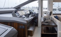 Interior helm of 2021 Sunseeker Manhattan 68 yacht, featuring modern controls and seating.