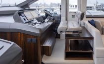 Luxurious helm station of 2021 Sunseeker Manhattan 68 yacht with modern controls and seating.