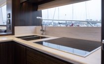 Luxurious kitchen interior of 2021 Sunseeker Manhattan 68 yacht with modern fixtures.