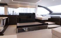 Luxurious interior of 2021 Sunseeker Manhattan 68 yacht with modern seating and TV.