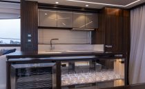 Luxurious interior of 2021 Sunseeker Manhattan 68 yacht with modern bar area.