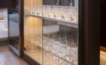 Luxurious glassware cabinet on 2021 Sunseeker Manhattan 68 yacht interior.
