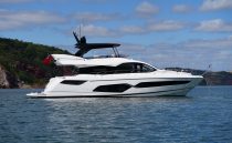 2021 Sunseeker Manhattan 68 yacht on calm sea under blue sky.