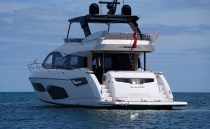 2021 Sunseeker Manhattan 68 yacht on calm ocean waters.